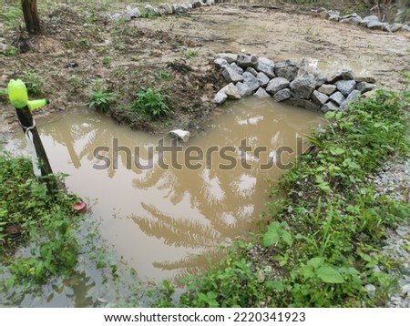scene of the rain water flooded the farm concrete cylindrical drain