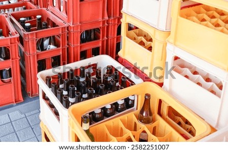  Scene of several empty beer bottles collected and lined up in an orderly fashion.          
