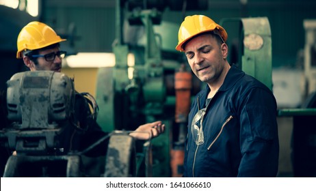 Scene Shot Of 2 Industrial Workers Feeling Upset With The Engine Machine Of The Factory, Arguing Planning, The Procedure Of Work In The Factory, Concept Industrial Worker Life, Working Confliction.