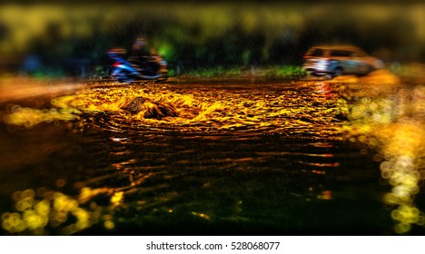 scene with tilt shift effect. dirty water hurls vehicle that falls on the road potholes. Improper asphalt.