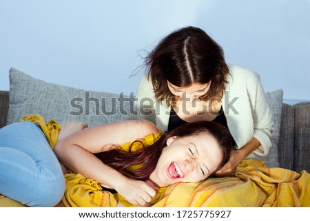 Similar – Image, Stock Photo Happy couple laughing and covering mouths under duvet