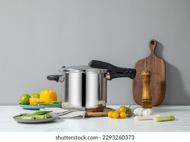 The scene of using a pressure cooker to make soup and cook dishes in the kitchen, marble countertop background, wood grain desktop.