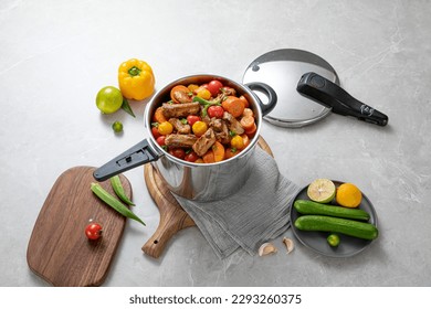 The scene of using a pressure cooker to make soup and cook dishes in the kitchen, marble countertop background, wood grain desktop. - Shutterstock ID 2293260375