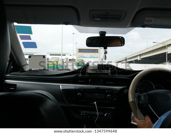 The scene of the view from the taxi\
car with taxi meter display in bangkok, Thailand\
