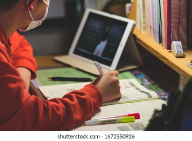 A scene where a child wearing a mask studies at home using a tablet / Japanese kids. - Powered by Shutterstock