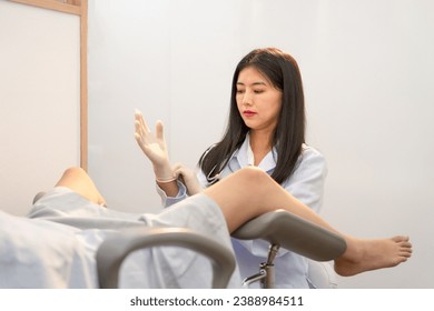 scene of a woman gynecologist is wearing medical gloves and doing internal examination of a female patient or pregnant woman that lying on a gynecological chair in the medical treatment room - Powered by Shutterstock