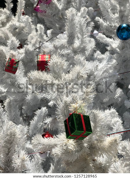 Scenery\
background of the white Christmas tree decoration with gift box and\
ornaments for new year and Christmas\
festival