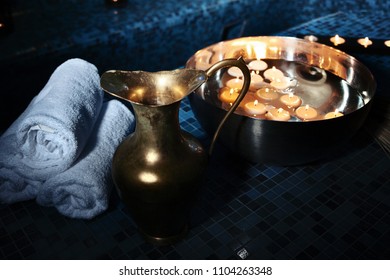 Scenery Baths Hammam, Spa Procedures. Copper Jug, Bowl With Burning Candles, White Towels