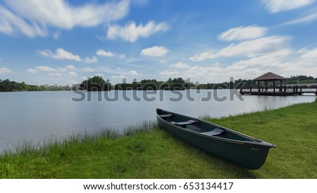 Scenery of beautiful cloud with canoe rests on a shore. Wetland Putrajaya Lake