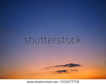 Scenery of blue and orange sky with gray clouds after Sunset in the evening.