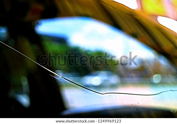 scenery blurry vision of cracked on glass at\
front window of automobil in closeup and minimal style so\
impressive pattern for object\
background
