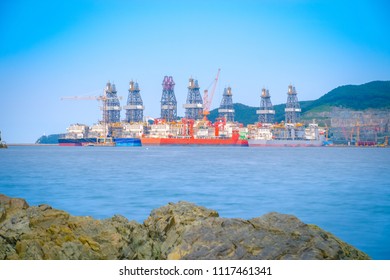 Scenery of commercial ship, large crane, platform and large in the harbor, South Korea.