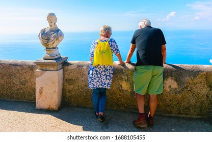 Scenery with couple of senior tourists enjoying views of Ravello village in Italy at Naples. Amalfi coast and landscape with people at Tyrrhenian Sea at Italian Amalfitana coastline in Europe. Summer. - Powered by Shutterstock