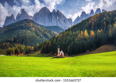 Scenery of Dolomites with the St. John's in Ranui Chapel (La Chiesetta di San Giovanni in Ranui), Santa Maddalena. Italy