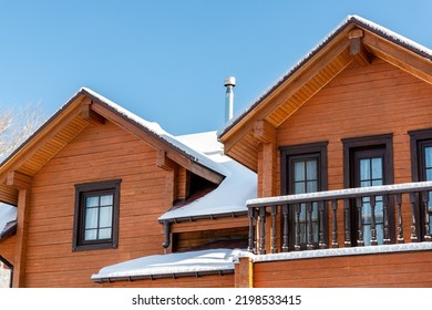 Scenery Facade Front View Of Modern Wooden Luxury Timber Eco House Villa With Garage Door Snowcapped By White Fresh Snow At Cold Sunny Winter Day. Real Estate Building Construction Project Exterior