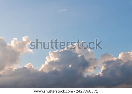 Scenery with giant clouds and blue sky