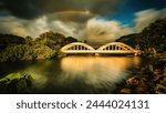 Scenery of Haleiwa bridge with rainbow background 