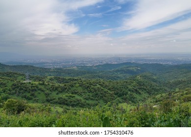 The scenery mountain valley view with rocks, forests and meadows in Tian Shan mountains in Central Asia near Almaty covered by clouds. Best place for active life, climbing, hiking and trekking.