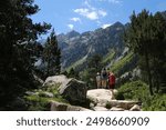 Scenery of Pyrenees National Park. 
Silhouettes of people on trail from Cauterets to lake Lac de Gaube. France