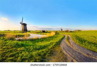 Scenery road to old Dutch windmill farm
