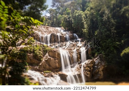 Scenery of Sungai Pandan Water Fall. Long exposure photography of a rainforest water fall. Waterfall in tropical forest at Malaysia. Beautiful waterfall in the forest. Soft water flow.