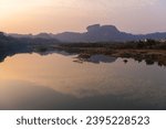 The scenery of Wuyishan landscape of Wuyi Mountains, peaks and the River of Nine Bends, Fujian province, China. Sun setting behind the mountain