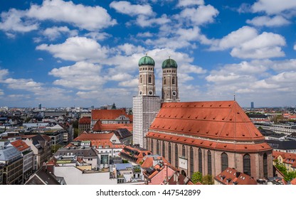 Scenic aerial panoramic view of the Old Town architecture - Munich cathedral church Frauenkirche under blue sky with clouds, Munchen, Bavaria, Germany   