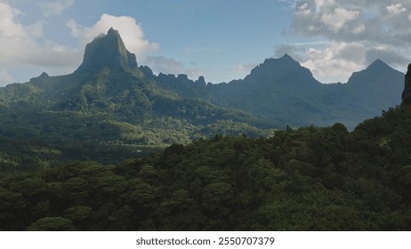 Scenic aerial perspective of green rainforest blanketing the rugged volcanic mountains peaks, stunning panorama of Moorea tropical island in French Polynesia. Remote wild nature travel background - Powered by Shutterstock