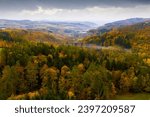 Scenic aerial view of autumn hilly landscape with colored trees