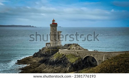 A scenic aerial view of Le Phare du Petit Minou lighthouse on cloudy day in Plouzane, France
