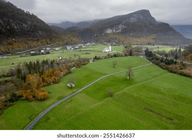 Scenic aerial view of a winding road through green meadows, leading to a charming church nestled in the bohinj valley, slovenia - Powered by Shutterstock