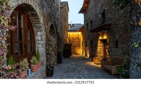 The scenic architecture of spanish village in mountain in Pyrenees mountains, Huesca, Aragon, Spain. Village of Anso, one of the most beautiful villages in Spain at the sunset. - Powered by Shutterstock