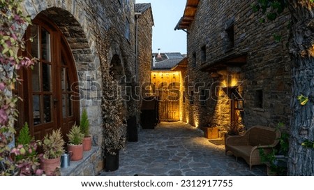 The scenic architecture of spanish village in mountain in Pyrenees mountains, Huesca, Aragon, Spain. Village of Anso, one of the most beautiful villages in Spain at the sunset.