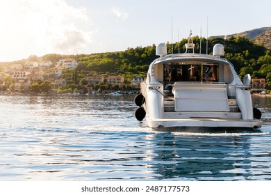 Scenic back view luxury private yacht boat sail at Croatian bay harbor shore blue turquoise clear water bright summer sunny sunset sunrise morning. Rich quality lifestyle. Boat vessel charter service - Powered by Shutterstock