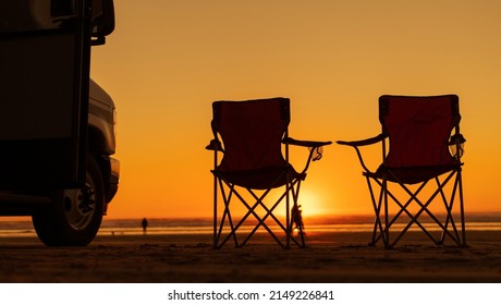 Scenic Beach Sunset Vista with RV Motorhome and Two Camping Chairs. California Coast, United States of America.