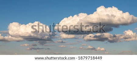 Scenic beautiful wide fantasy dream cloudscape panoramic landscape of beautiful evening or morning blue sky background. Fluffy cumulus cloud floating in clear skyline horizon. Natural sky panorama