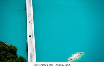 Scenic Bridge Over Canyon Lake Piva In Montenegro From Above With Beautiful Color Os Water. Aerial Drone View On Nature In National Park