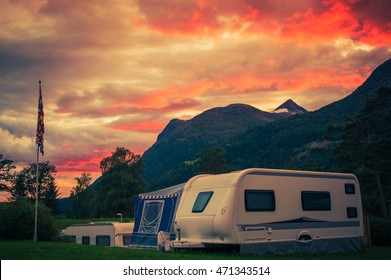 Scenic Camping Sunset. Sunset Sky Over Campground With Travel Trailers. Campsite Caravan Camping.