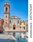 The scenic Chiesa del Carmine, located in the centre of Comacchio, picturesque town with canals and bridges in the province of Ferrara, Italy