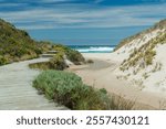 Scenic coastal pathway leading to a serene beach in Western Australia. Surrounded by dunes, native vegetation, and turquoise ocean waves, this tranquil spot captures the essence of untouched nature.