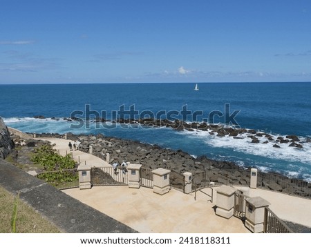 Scenic coastal view with waves rolling over the rocks behind El Morro Fort in San Juan, Puerto Rico.  