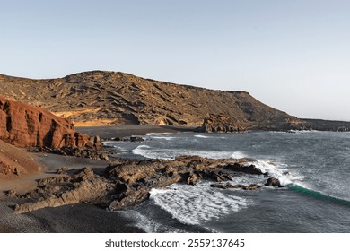 Scenic coastline with rocky shores and gentle waves during sunset - Powered by Shutterstock