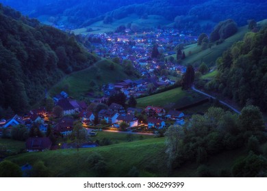 Scenic countryside landscape with beautiful mountain village in late evening. Germany, Black forest, Muenstertal. Aerial panorama.