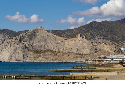 Scenic Crimean landscape with blue water of Black Sea and ancient Genoese fortress on background of mountains. Tourist attraction of resort Sudak city. Sudak, Crimea, Russia – October 2, 2019 - Shutterstock ID 1638232243
