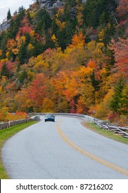 Scenic Drive. A Car, Surrounded By Colorful Fall Foliage,  Travels The Scenic Blue Ridge Parkway, North Carolina.