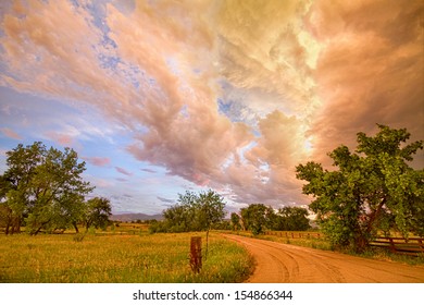 A scenic drive on a dirt country road in North Boulder County Colorado with a magical colorful view of the leading edge of a beautiful dramatic storm cloud front. 