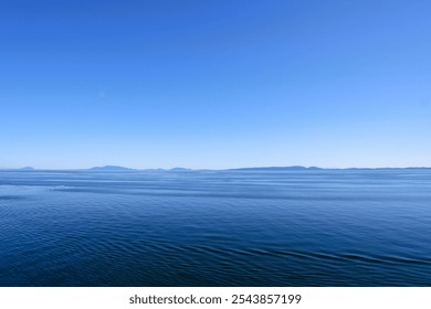 Scenic Ferry View of Vancouver Island with Clear Blue Sky, Calm Water, and Islands in the Background – Captured During the Ferry Ride to Vancouver Island Canada - Powered by Shutterstock