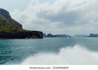 Scenic Halong Bay, Vietnam. Jagged rock formations, turquoise waters, boat wake, white foam - a dynamic view. - Powered by Shutterstock