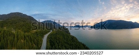 Scenic Highway on the ocean coast with mountain landscape. Sea to Sky Hwy, North of Vancouver, BC, Canada. Aerial view. Sunset