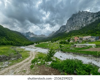 Scenic hiking trail from Kukaj to Maja Jezerce in Valbone Valley National Park, Albania. Majestic cloud covered mountain peaks of Albanian Alps (Accursed Mountains). Forest covered steep alpine slopes - Powered by Shutterstock